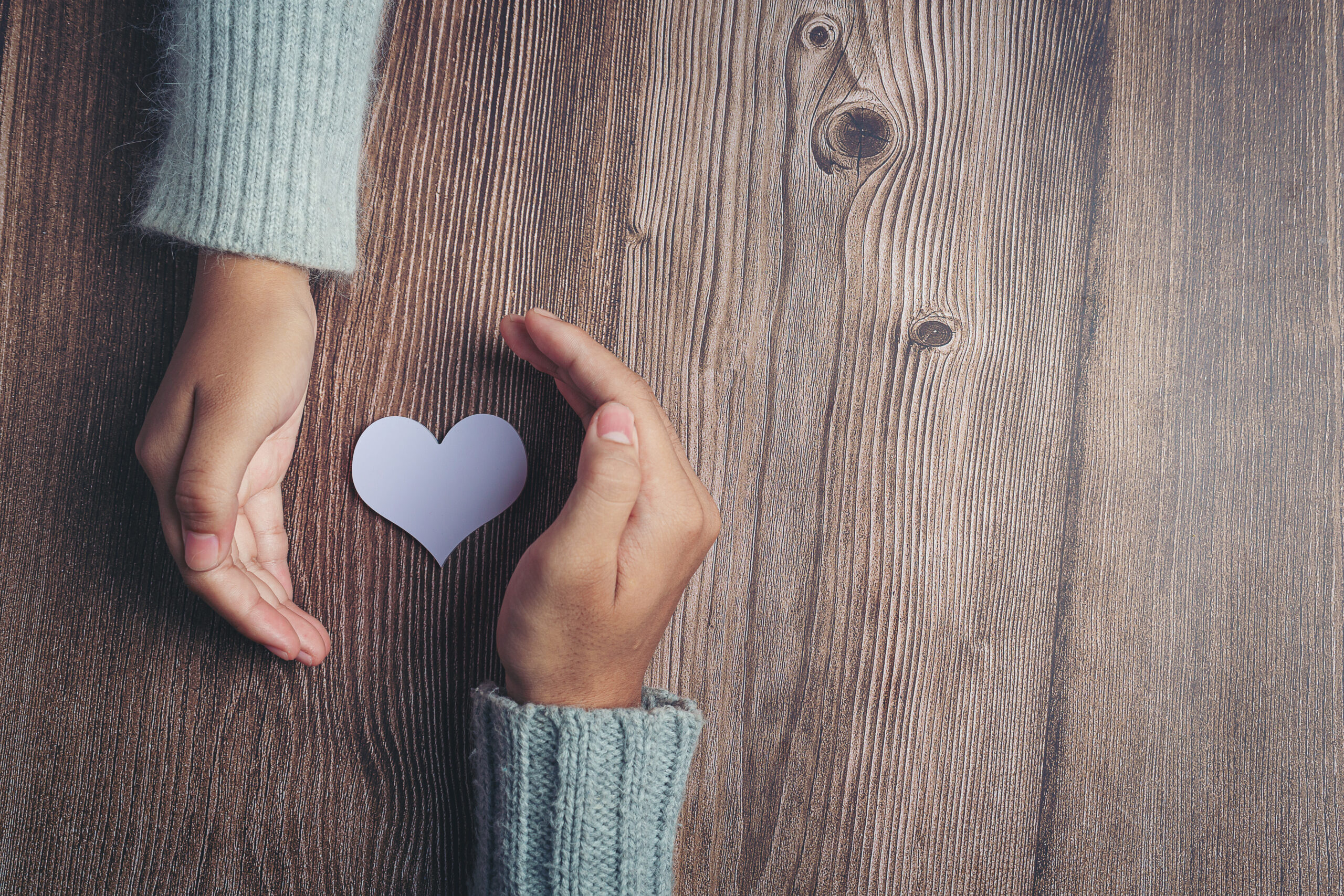Paper heart held in hands representing support for GoLife